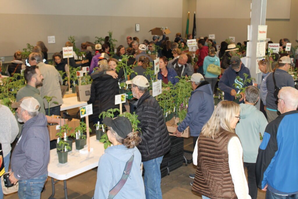 Plant sale shoppers fill the room.