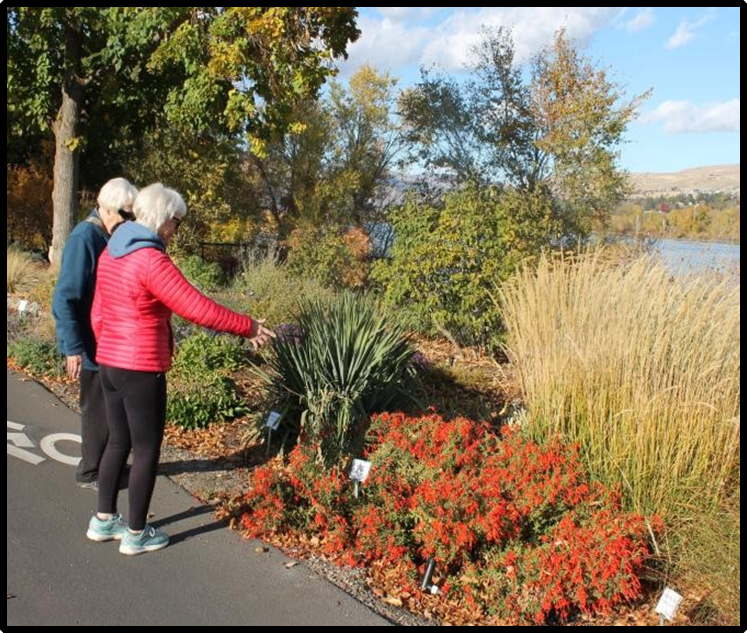 Two visitors at the Xeric Garden discuss the plantings.
